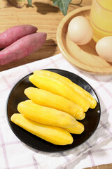 Date-shaped Tianmu sweet potato sticks with fresh ingredients on rustic wooden kitchen table
