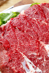 Fresh Raw Beef Brisket with Marbling on White Plate Ready for Cooking