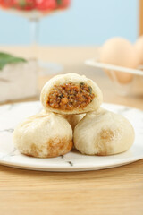 Traditional Shengzhou Xiao Long Bao Chinese Dumplings with Savory Filling on White Plate