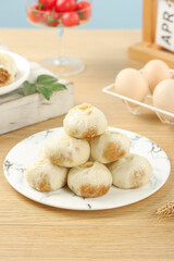 Traditional Chinese Steamed Buns Baozi on White Plate with Kitchen Ingredients Background