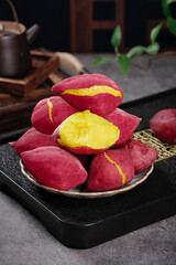 Fresh Sweet Potatoes with Golden Flesh on Rustic Plate - Traditional Asian Cooking Ingredient