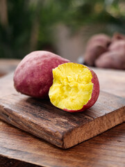 Fresh Sweet Potatoes with Yellow Flesh on Wooden Cutting Board - Healthy Organic Root Vegetables