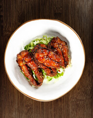 Smoked Pomfret Fish Shanghai Style - Traditional Chinese Cuisine Specialty Dish with Sesame Seeds and Lettuce Garnish