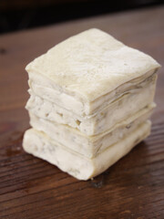 Fresh Tofu Blocks Stacked on Wood Surface for Healthy Asian Cooking and Meal Prep