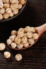 Xinjiang Fried Chickpeas with Five Spice Salt Seasoning in Wooden Spoon on Dark Background