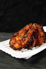 Shanghai Style Smoked Fish with Sesame Seeds and Scallions on White Plate - Chinese Cuisine Specialty