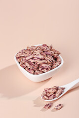 Appetizing Colorful Speckled Dried Beans in Bowl - Healthy Legumes and Protein Rich Food Ingredients