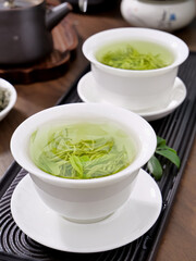 Xinyang Maojian Green Tea Ceremony - Traditional Chinese Tea Culture with Steeping Leaves in White Porcelain Cups