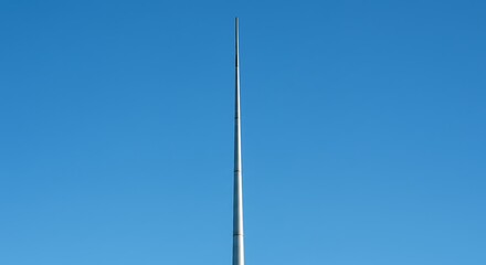 Obraz premium Sleek metal spire reaching into bright blue sky daytime architectural structure