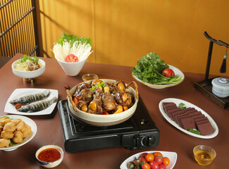 Hot Pot Lamb Stew with Fresh Vegetables and Noodles on Wooden Table Traditional Asian Cuisine Setup