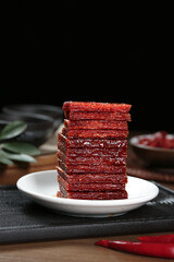Spicy Red Beef Jerky Stack on White Plate - High Protein Dried Meat Snack