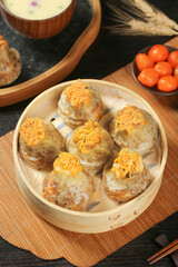 Chinese Siu Mai Dumplings with Salted Egg Yolk in Bamboo Steamer - Traditional Dim Sum Cuisine