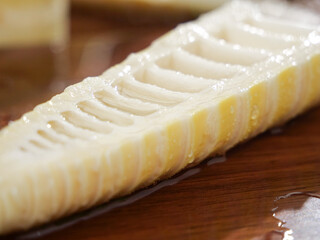 Fresh Peeled Bamboo Shoot Slice on Wood Surface - Asian Cooking Ingredient