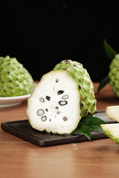 Fresh Soursop Custard Apple Fruit Sliced Open on Wooden Board