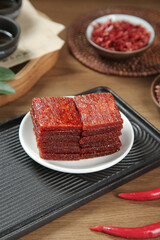 Korean Gochujang Spicy Red Pepper Paste Squares on Grill Pan with Chili Peppers