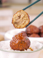 Lion's Head Meatball with Chopsticks - Traditional Chinese Braised Pork Dish at Special Banquet