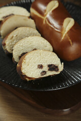 Handmade Whole Wheat Bread Bars with Raisins Sliced on Dark Plate