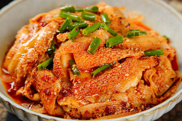Spicy Korean beef tripe with chili oil and green onions in bowl