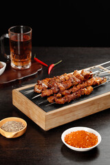 Grilled Meat Kebabs on Wooden Board with Spices and Tea - Traditional BBQ Cuisine