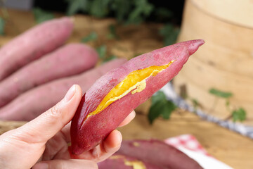 Fresh Roasted Sweet Potato with Golden Flesh in Hand - Healthy Organic Vegetable Food