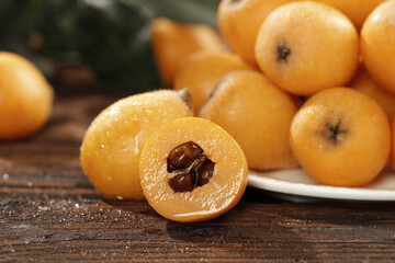 Fresh Loquat Fruits from Panzhihua Sichuan - Traditional Chinese Alpine Fruit with Seeds Displayed on Wood Surface