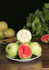 Fresh Tropical Guava Fruit with Pink Heart Center on Wooden Table - Healthy Exotic Food Photography