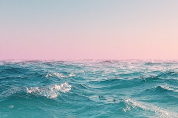Fototapeta premium Serene teal ocean under a soft pink and pastel sky at sunset, gentle waves ripple across the water's surface