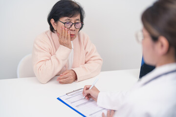 Fototapeta premium Elderly woman Patient having Toothache and consulting Doctor to teeth disease. Senior Health Medical Diagnosis. Oral Teeth decay, Scrape off tartar. March Oral health, Dentist day and Consultation