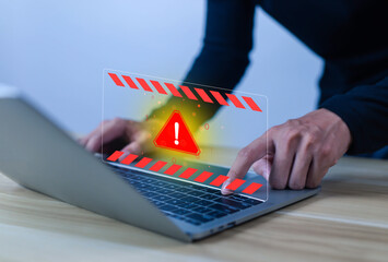 Cybersecurity warning concept showing a red alert symbol on laptop screen, representing virus attack, malware, system error, online data breach, and computer security risk.