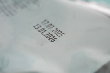 Expiration dates printed on a package lying on a surface