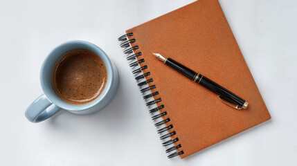 A still life with a cup of coffee, a notepad, and a pen, perfect for creative writing or journaling. The scene exudes a sense of calm and invites contemplation