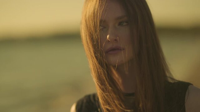 Cinematic portrait of a woman finding joy in the fading light of the beach.

