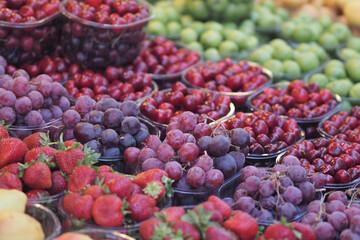 Fresh fruits displayed in colorful market baskets