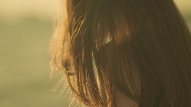 Cinematic portrait of a woman finding joy in the fading light of the beach.


