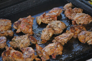 Grilling marinated chicken on a barbecue grill outdoors
