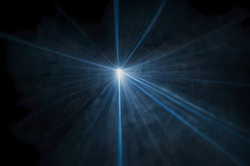 White and blue laser beams shining in a dark fog.