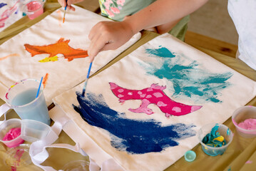Kids art class painting creatively on canvas totes birthday party activity 