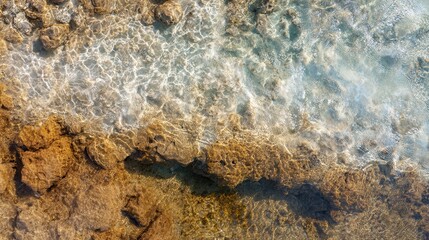 A tranquil scene showcasing clear water lapping against rocky shores, highlighting the interplay of light on water and the natural textures of the landscape.