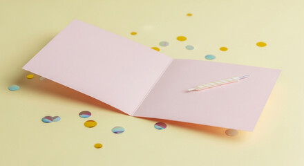 Minimalist Birthday Card Open on Pastel Yellow Background with Candle and Confetti