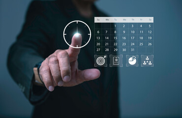 Businessman hand pointing at digital calendar with clock and icons, symbolizing time management, productivity planning, scheduling tasks, business strategy, and efficient organization.