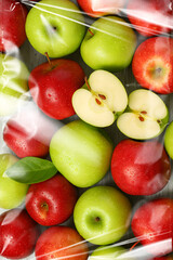 Fresh Red and Green Apples with Halves Close Up in Transparent Packaging