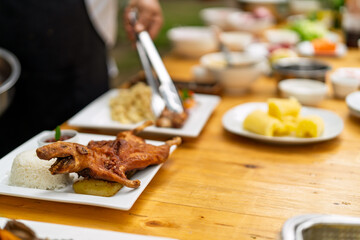 Chef serving whole roasted guinea pig with rice
