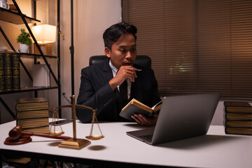 Male lawyer working on legal matters in a law office	