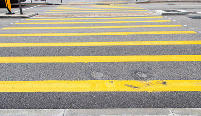 Zebra crossing yellow, black traffic walkway road. Symbol for road traffic. Drivers must obey traffic signals or traffic signs. Important part that helps make roads safe and helps reduce accidents.
