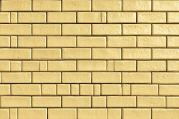 Fototapeta premium A close-up background view of a light yellow brick wall featuring a decorative bond pattern and textured surfaces on each brick