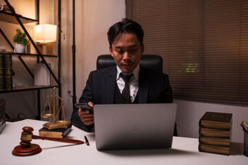 A lawyer is reading a book about law in the office.

