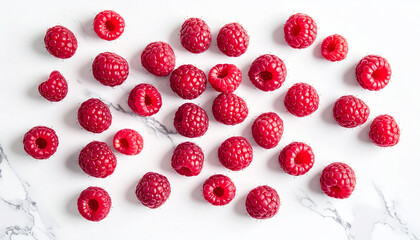 Fresh raspberries scattered on a white marble surface, photographed in bright minimalist spring food style