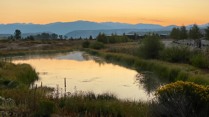 Sunrise Over Rocky Mountains with Pond