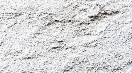 Fototapeta premium A close-up view of a rough white textured wall background with uneven patterns and shadows highlighting its coarse surface