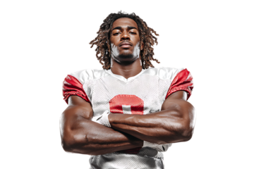 A muscular african american football player with dreadlocks stands with his arms crossed, isolated on a transparent background